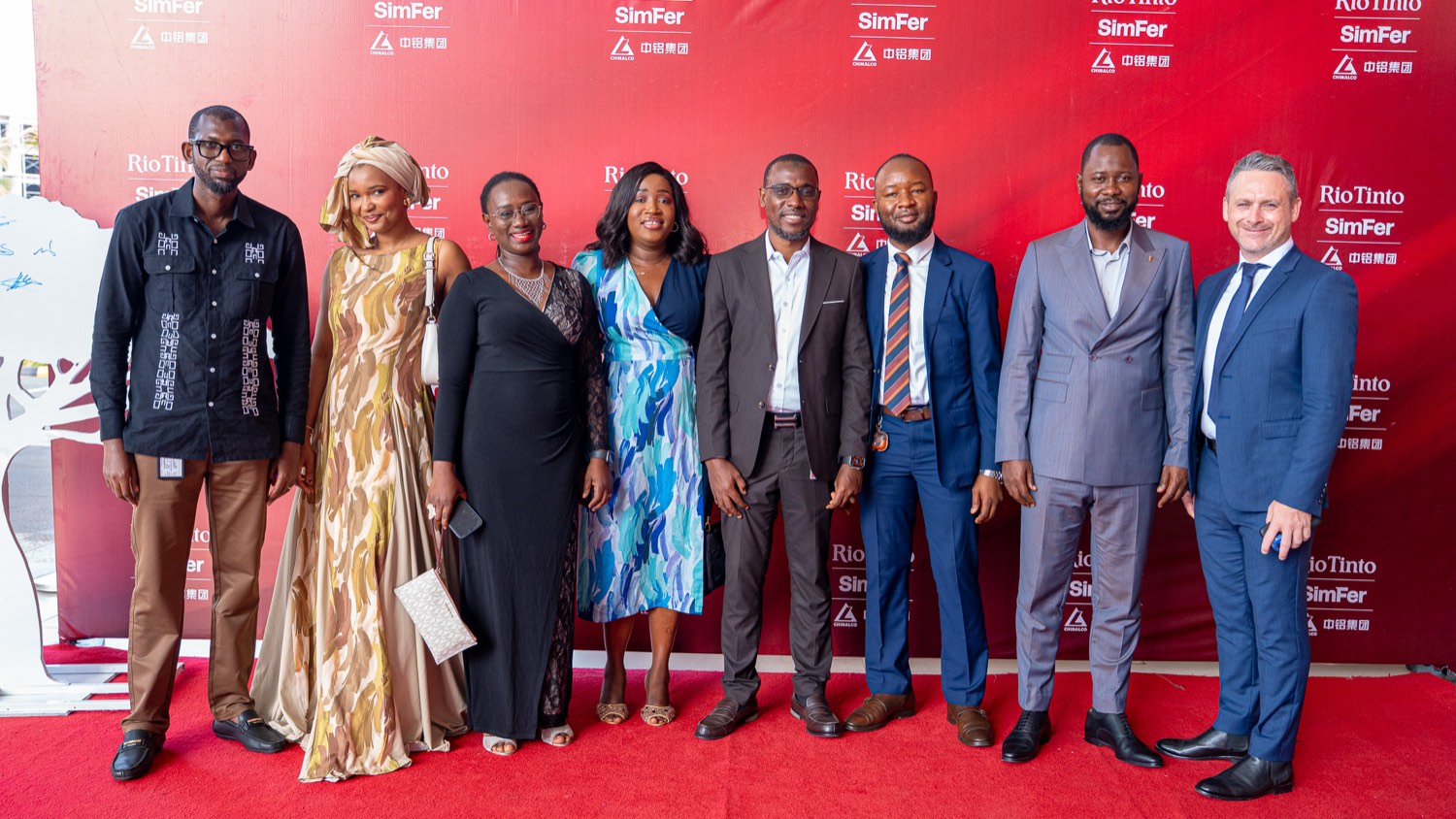 Group photo of the eight 2026 Supplier Award winners standing in front of a Rio Tinto and SimFer branded backdrop at the ceremony in Conakry.