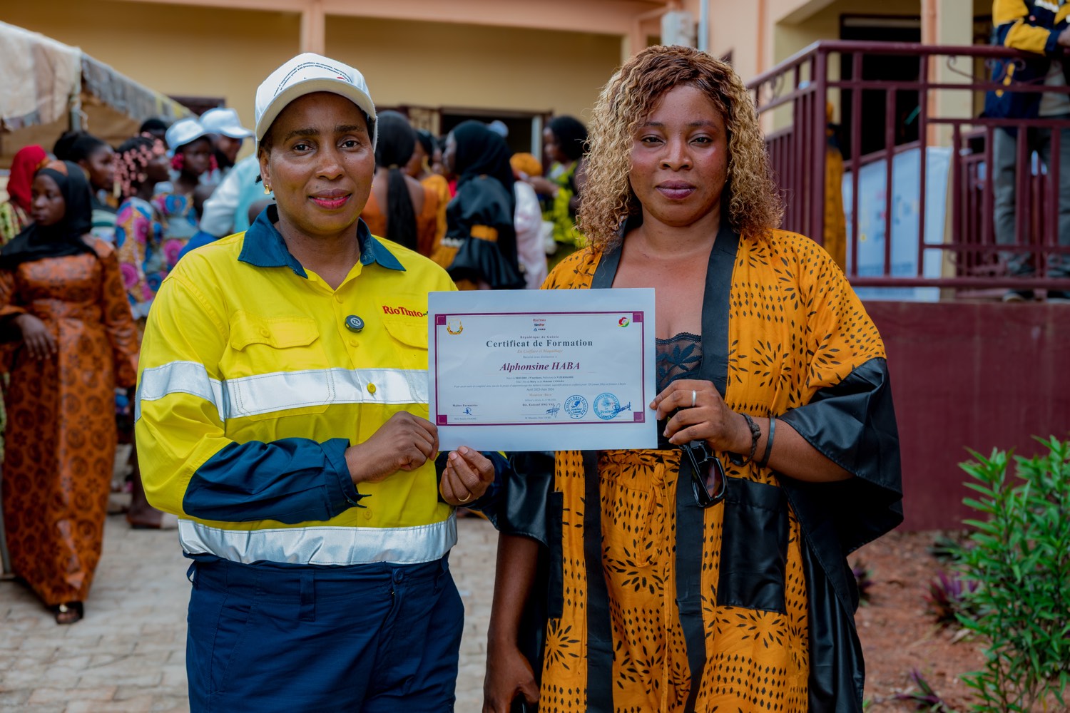A Rio Tinto SimFer team member presents a training certificate in Beyla
