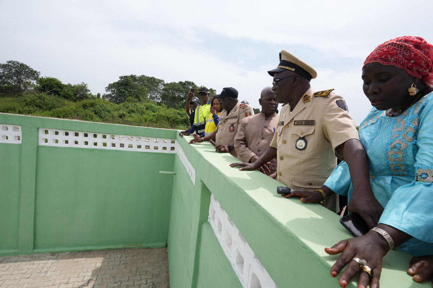 Officials visit a waste storage and composting facility